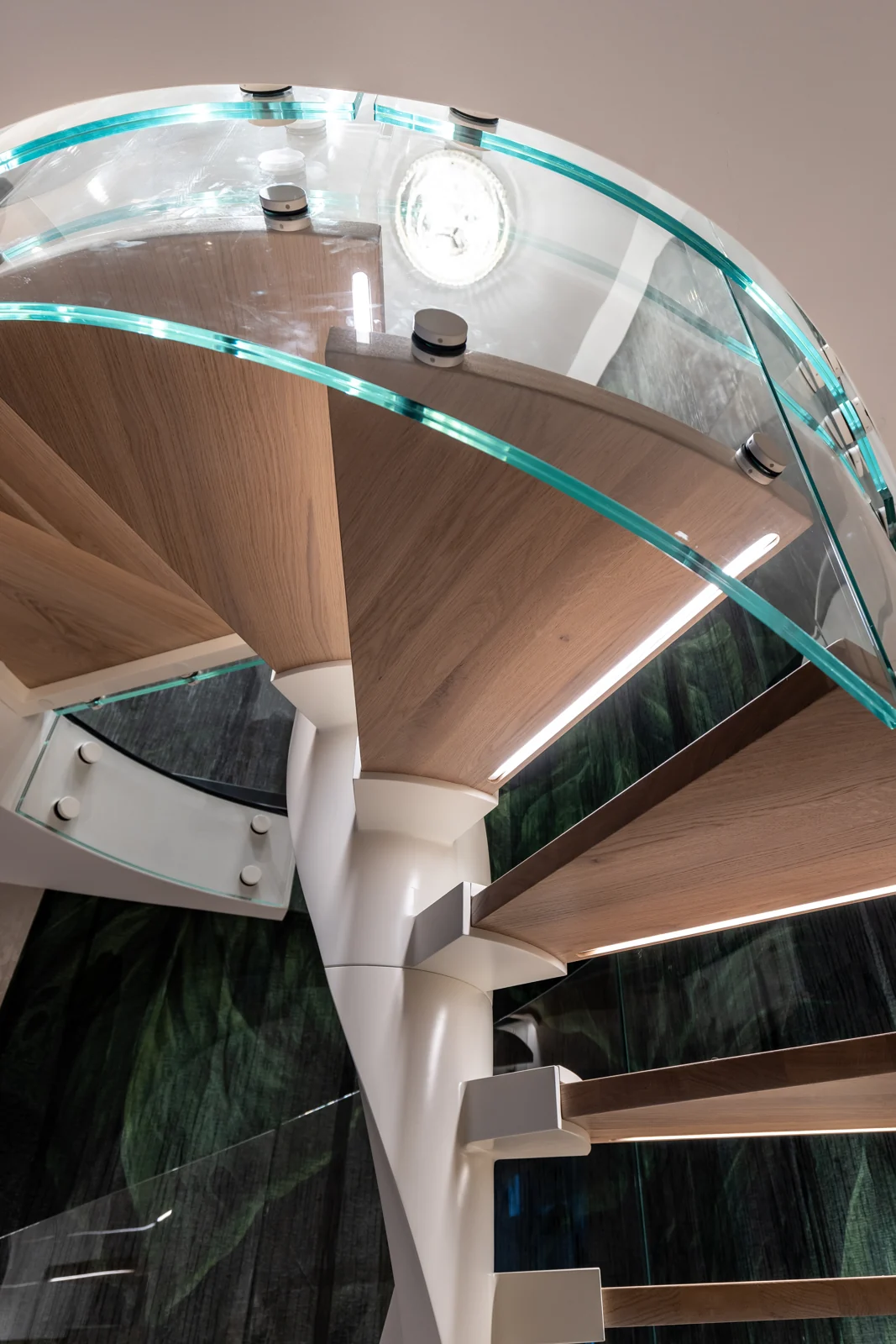 Detail of timber treads and a curved glass balustrade