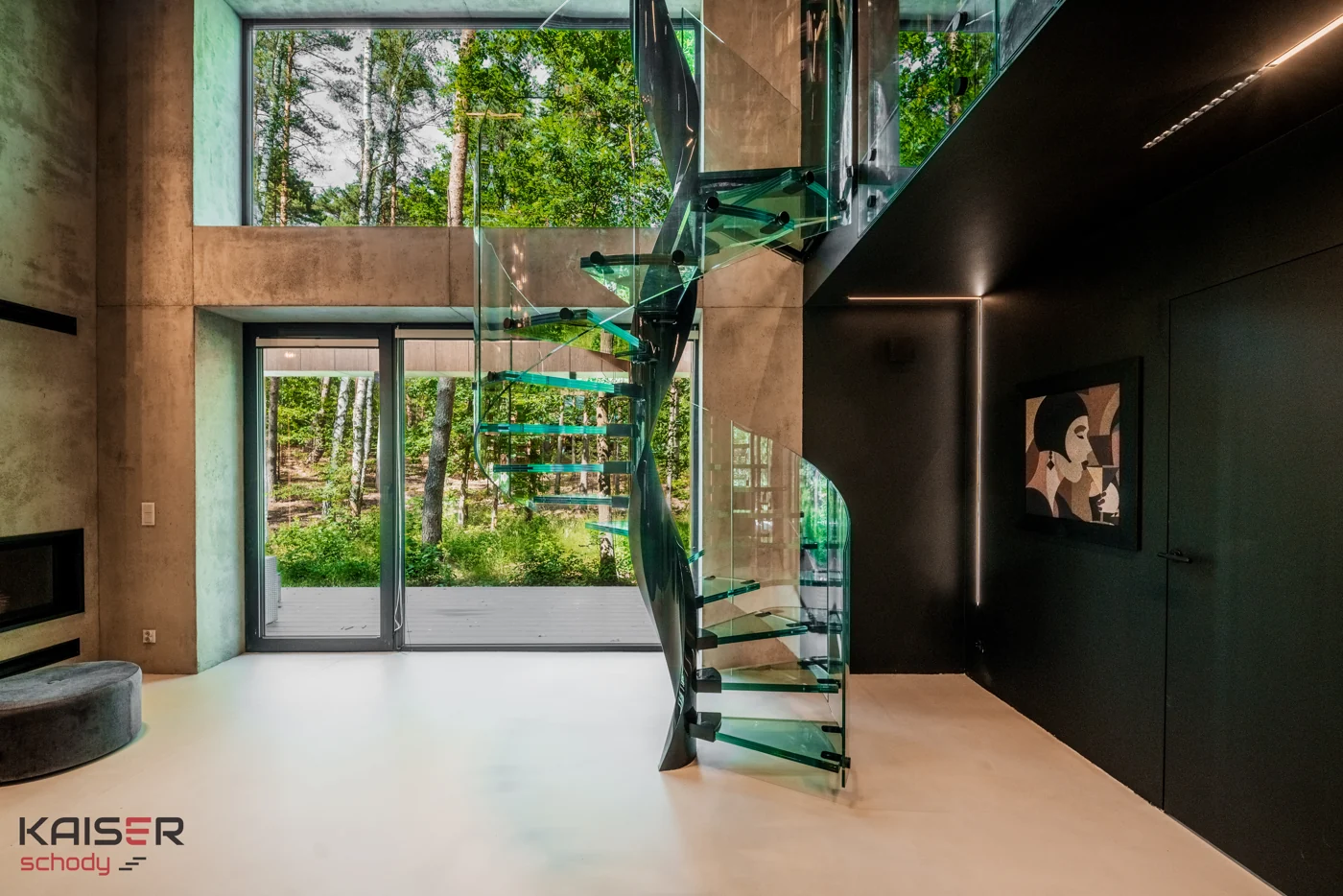 Dark spiral staircase with glass treads in a double-height interior